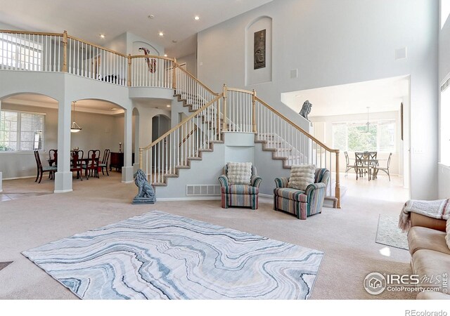 7858 Oban Ct, Lone Tree, CO 80124 - living room featuring a towering ceiling, carpet floors, stairway, arched walkways, and recessed lighting