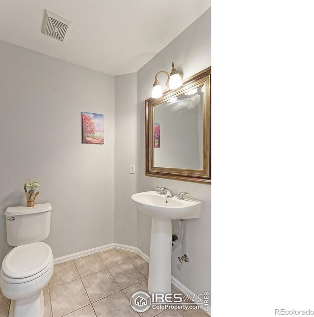 7858 Oban Ct, Lone Tree, CO 80124 - half bathroom with baseboards, toilet, and tile patterned floors