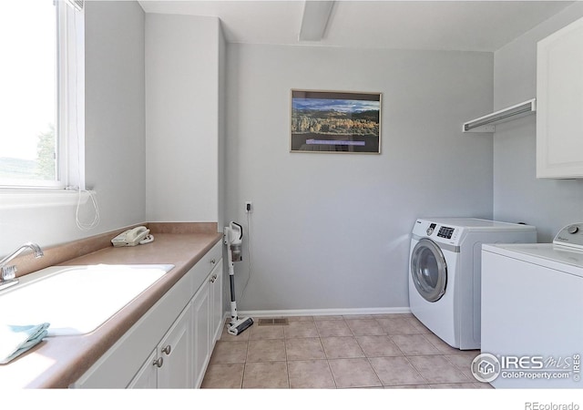 7858 Oban Ct, Lone Tree, CO 80124 - laundry area with separate washer and dryer, cabinet space, light tile patterned floors, and baseboards