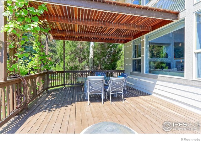 7858 Oban Ct, Lone Tree, CO 80124 - wooden deck with outdoor dining area and a pergola