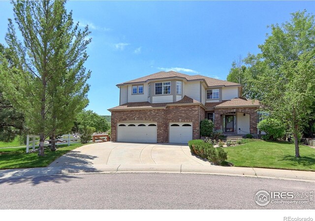 7858 Oban Ct, Lone Tree, CO 80124 - traditional home featuring an attached garage, driveway, a front yard, brick siding, and roof with shingles