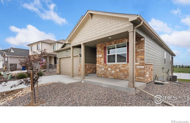 4709 Lynxes Way, Johnstown, CO 80534 - craftsman inspired home with stone siding, covered porch, an attached garage, driveway, and central AC unit