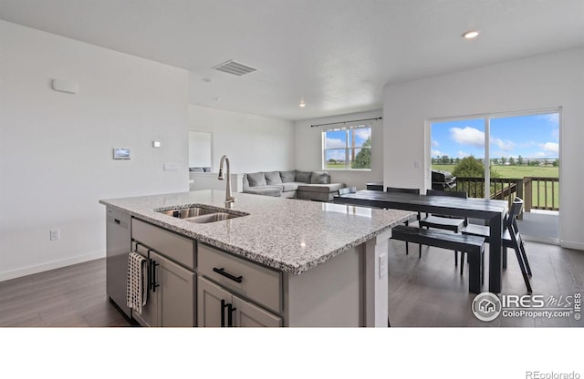 4709 Lynxes Way, Johnstown, CO 80534 - kitchen with a sink, dark wood finished floors, recessed lighting, light stone counters, and baseboards