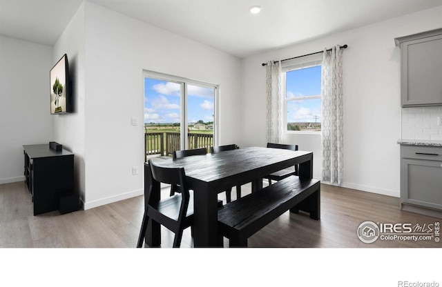 4709 Lynxes Way, Johnstown, CO 80534 - dining area featuring plenty of natural light, light wood finished floors, and baseboards