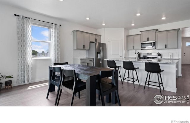 4709 Lynxes Way, Johnstown, CO 80534 - dining room with dark wood finished floors, recessed lighting, and baseboards