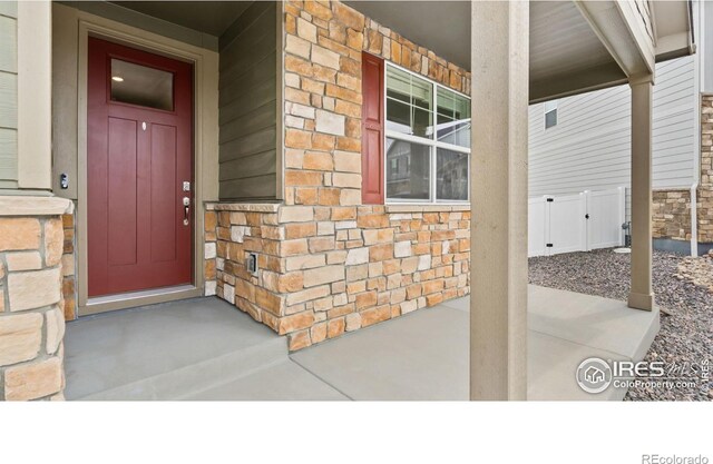 4709 Lynxes Way, Johnstown, CO 80534 - property entrance featuring stone siding and a porch