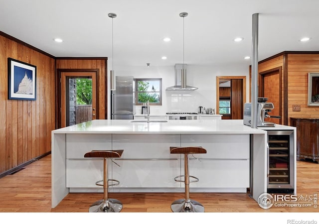 1484 Wicklow St, Boulder, CO 80303 - kitchen with island exhaust hood, stainless steel refrigerator, beverage cooler, a sink, and light wood finished floors
