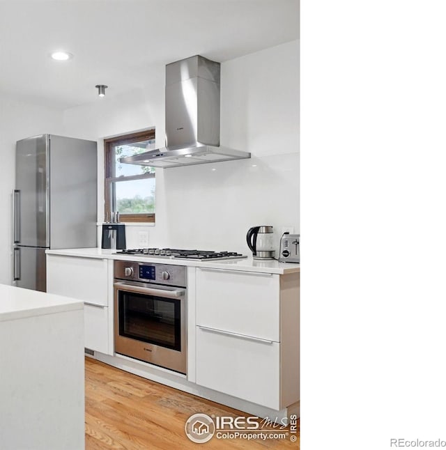 1484 Wicklow St, Boulder, CO 80303 - kitchen with stainless steel appliances, ventilation hood, modern cabinets, white cabinets, and light countertops