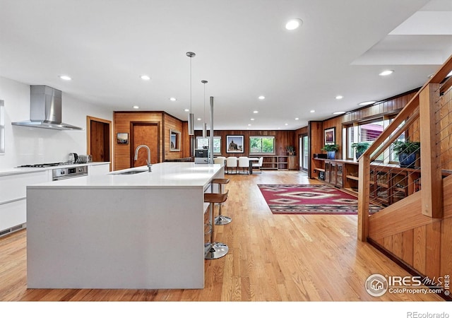 1484 Wicklow St, Boulder, CO 80303 - kitchen featuring a sink, wall chimney range hood, a large island, recessed lighting, and light countertops
