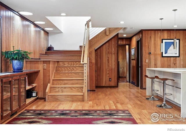 1484 Wicklow St, Boulder, CO 80303 - staircase featuring wooden walls, wood finished floors, and recessed lighting