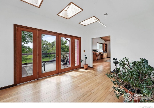 1484 Wicklow St, Boulder, CO 80303 - foyer featuring a skylight, french doors, light wood-type flooring, and baseboards