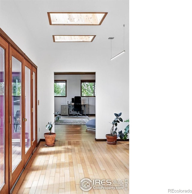 1484 Wicklow St, Boulder, CO 80303 - corridor with hardwood / wood-style flooring, a skylight, a desk, and baseboards