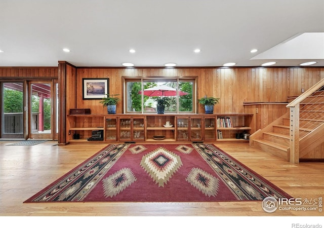 1484 Wicklow St, Boulder, CO 80303 - living area featuring wood walls, plenty of natural light, wood finished floors, stairway, and ornamental molding