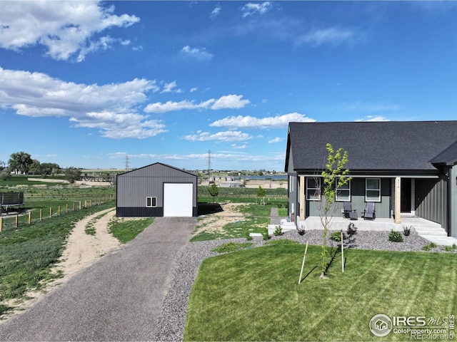 5016 Prairie Lark Ln, Severance, CO 80615 - view of yard featuring an outdoor structure, covered porch, a garage, and driveway