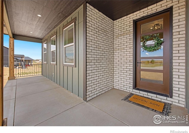 5016 Prairie Lark Ln, Severance, CO 80615 - entrance to property featuring board and batten siding, brick siding, and covered porch