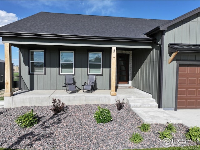 5016 Prairie Lark Ln, Severance, CO 80615 - property entrance with a porch, a shingled roof, and board and batten siding