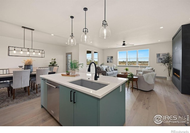 5016 Prairie Lark Ln, Severance, CO 80615 - kitchen featuring light wood-type flooring, green cabinets, recessed lighting, light countertops, and pendant lighting