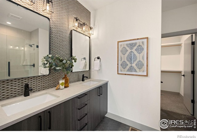 5016 Prairie Lark Ln, Severance, CO 80615 - full bath with double vanity, a shower stall, tasteful backsplash, and a walk in closet