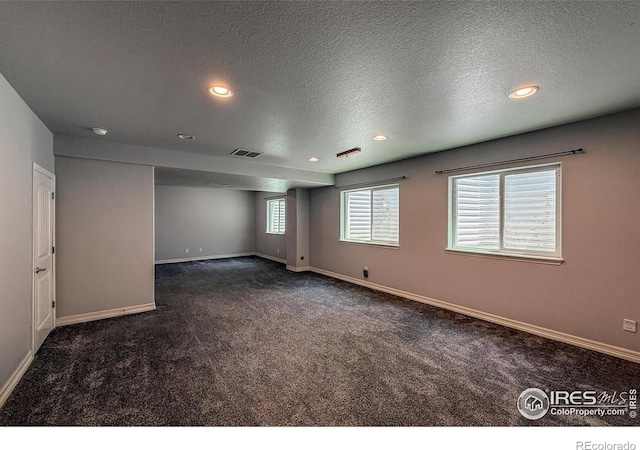 13598 Horseshoe Cir, Mead, CO 80542 - unfurnished room with dark carpet, a textured ceiling, baseboards, and recessed lighting