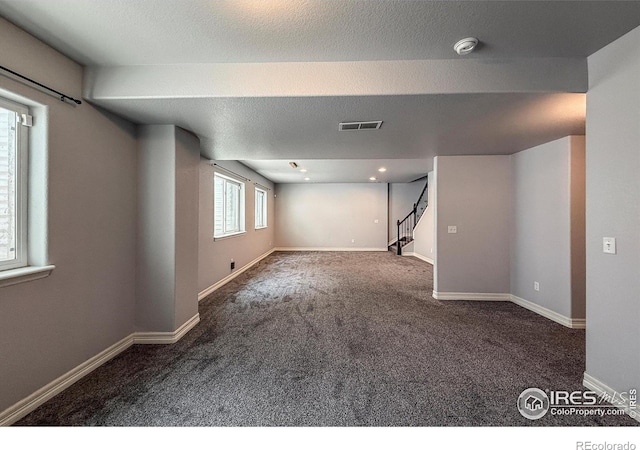 13598 Horseshoe Cir, Mead, CO 80542 - below grade area featuring carpet, stairway, baseboards, and a textured ceiling