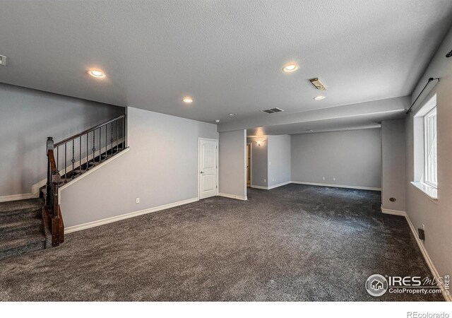 13598 Horseshoe Cir, Mead, CO 80542 - below grade area featuring carpet floors, stairway, recessed lighting, baseboards, and a textured ceiling