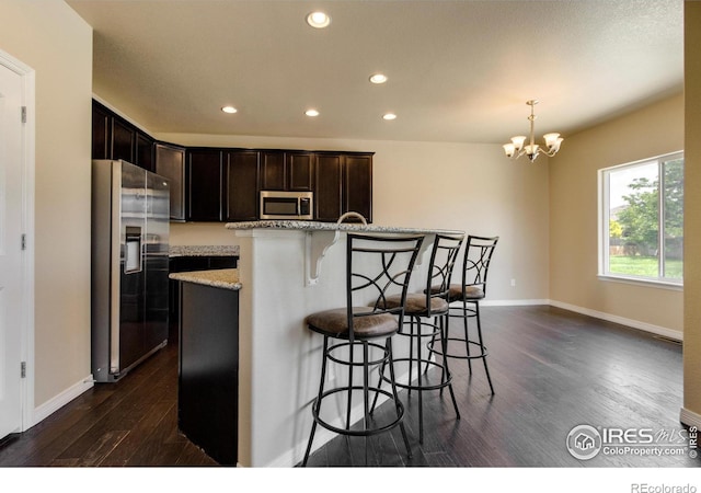 13598 Horseshoe Cir, Mead, CO 80542 - kitchen featuring stainless steel appliances, dark wood-type flooring, recessed lighting, dark brown cabinetry, and baseboards
