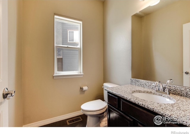 13598 Horseshoe Cir, Mead, CO 80542 - half bathroom featuring toilet, vanity, and baseboards