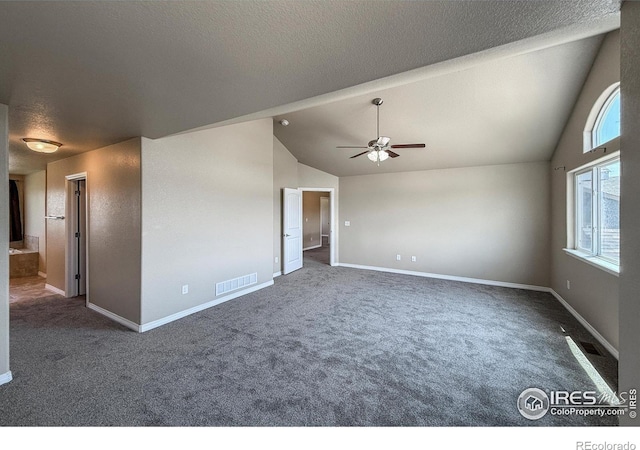 13598 Horseshoe Cir, Mead, CO 80542 - carpeted empty room with a textured ceiling, vaulted ceiling, a ceiling fan, and baseboards