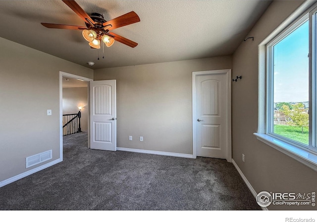 13598 Horseshoe Cir, Mead, CO 80542 - unfurnished bedroom featuring carpet, baseboards, a ceiling fan, and a textured ceiling