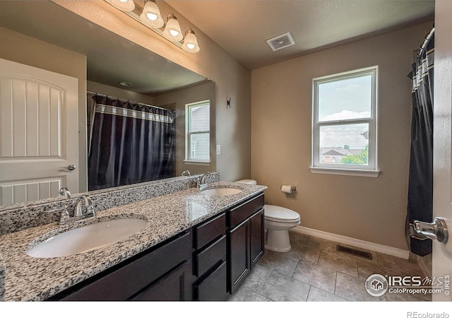 13598 Horseshoe Cir, Mead, CO 80542 - full bathroom featuring double vanity, toilet, baseboards, and tile patterned flooring