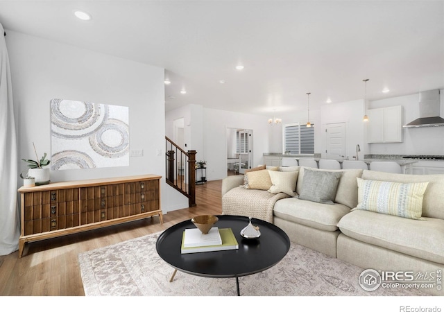 2031 Moon Rise Dr, Windsor, CO 80550 - living area featuring stairs, wood finished floors, recessed lighting, and a chandelier