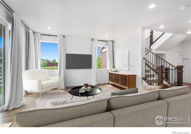 2031 Moon Rise Dr, Windsor, CO 80550 - living area featuring wood finished floors, recessed lighting, stairway, and baseboards