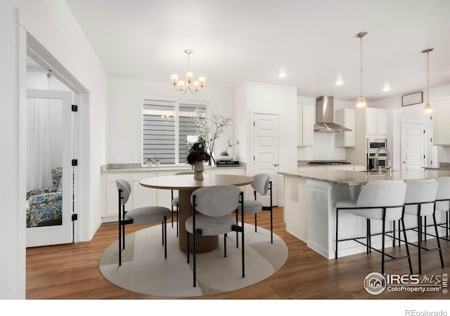 2031 Moon Rise Dr, Windsor, CO 80550 - dining room with recessed lighting, a chandelier, and wood finished floors