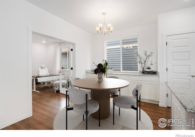 2031 Moon Rise Dr, Windsor, CO 80550 - dining space with wood finished floors and a chandelier