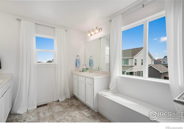 2031 Moon Rise Dr, Windsor, CO 80550 - bathroom with vanity and plenty of natural light