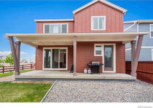 2031 Moon Rise Dr, Windsor, CO 80550 - back of property with a patio and board and batten siding