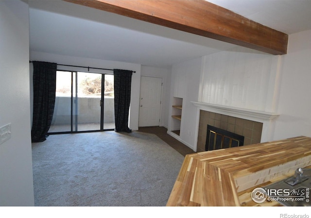 30 S Boulder Cir Unit 30182102, Boulder, CO 80303 - unfurnished living room featuring a tile fireplace, carpet flooring, and beamed ceiling