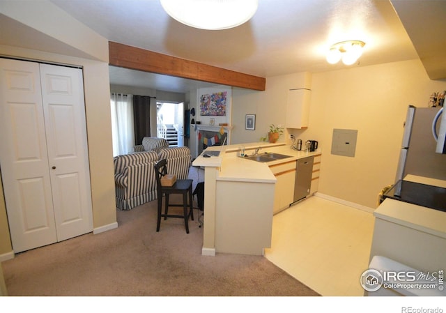 30 S Boulder Cir Unit 30182102, Boulder, CO 80303 - kitchen with a sink, a peninsula, appliances with stainless steel finishes, and light carpet