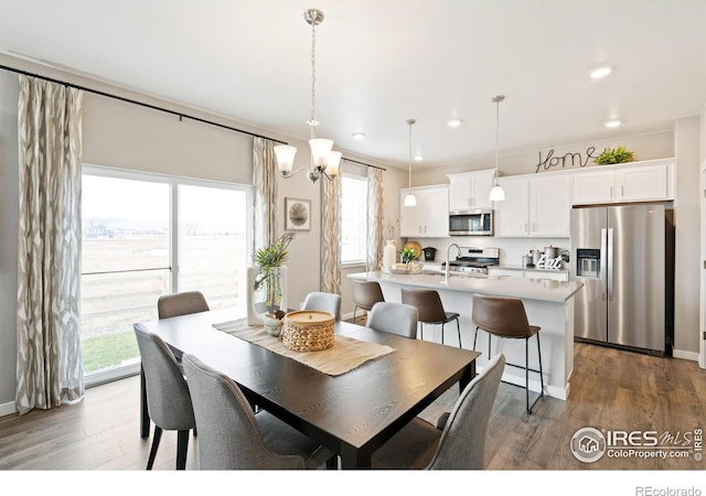 6506 13th St, Frederick, CO 80530 - dining area with dark wood-style flooring, recessed lighting, and a chandelier