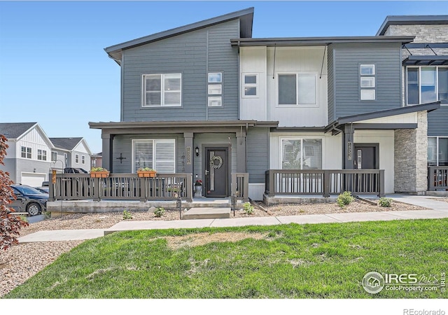 14553 W 91st Dr Unit A, Arvada, CO 80005 - multi unit property with a porch, a front lawn, and stone siding