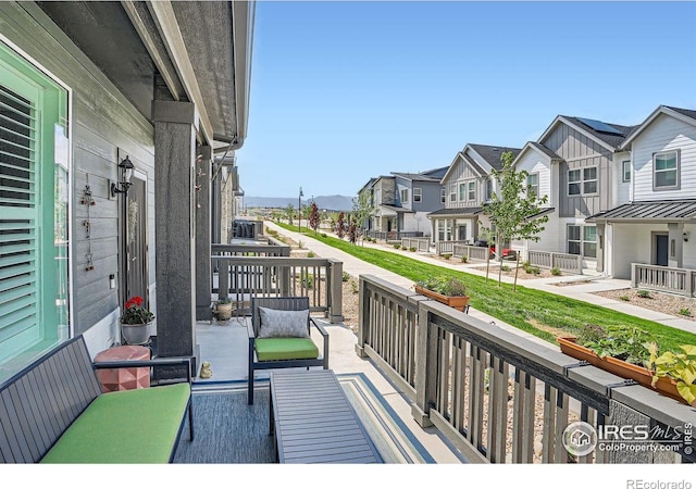 14553 W 91st Dr Unit A, Arvada, CO 80005 - covered porch featuring a residential view and an outdoor hangout area