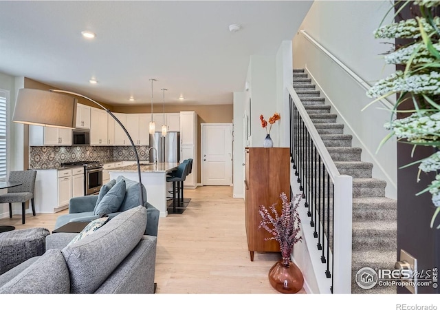 14553 W 91st Dr Unit A, Arvada, CO 80005 - living room featuring stairway, light wood-type flooring, and recessed lighting