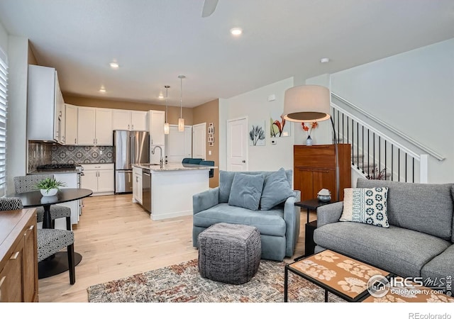 14553 W 91st Dr Unit A, Arvada, CO 80005 - living area featuring light wood-style flooring and recessed lighting