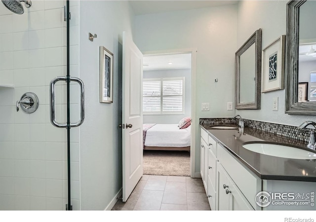 14553 W 91st Dr Unit A, Arvada, CO 80005 - bathroom with a shower stall, double vanity, connected bathroom, and tile patterned flooring