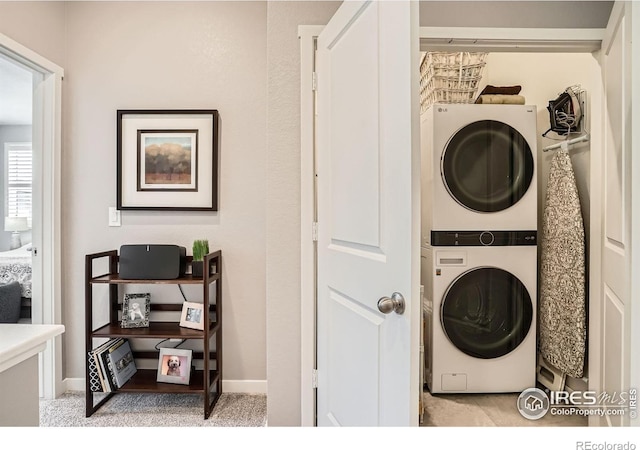 14553 W 91st Dr Unit A, Arvada, CO 80005 - washroom with stacked washer and clothes dryer and baseboards