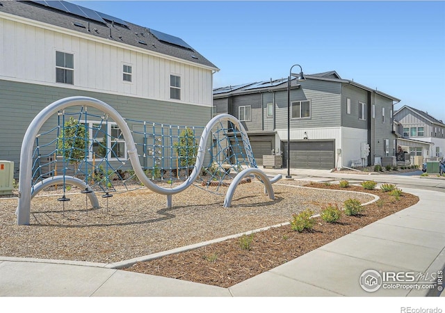 14553 W 91st Dr Unit A, Arvada, CO 80005 - view of community featuring concrete driveway, an attached garage, and a residential view