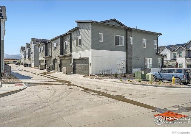 14553 W 91st Dr Unit A, Arvada, CO 80005 - view of concrete road with a residential view, curbs, and sidewalks