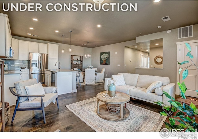 410 High Point Dr Unit 102, Longmont, CO 80504 - living room featuring recessed lighting, dark wood-type flooring, and a chandelier