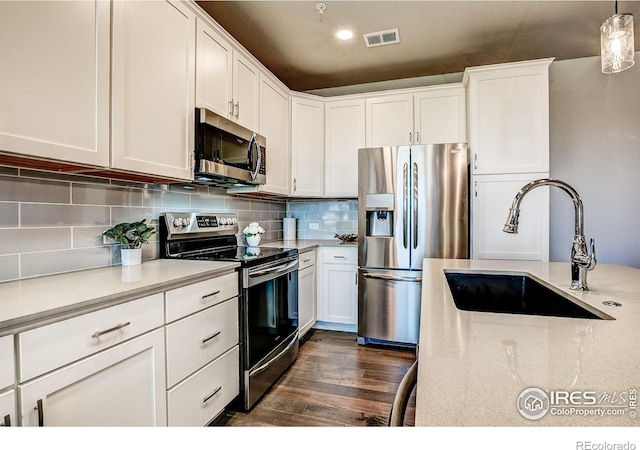 410 High Point Dr Unit 102, Longmont, CO 80504 - kitchen with appliances with stainless steel finishes, a sink, and white cabinetry