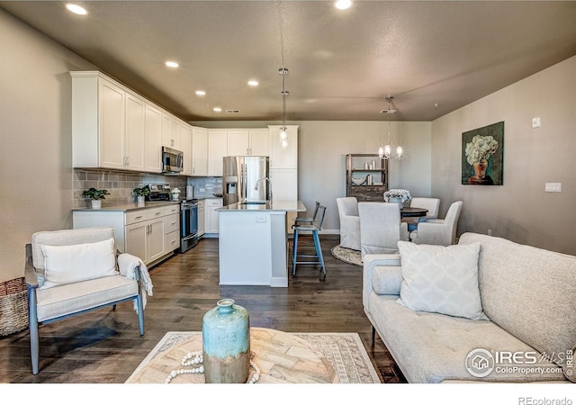 410 High Point Dr Unit 102, Longmont, CO 80504 - living room with a chandelier, dark wood-type flooring, and recessed lighting